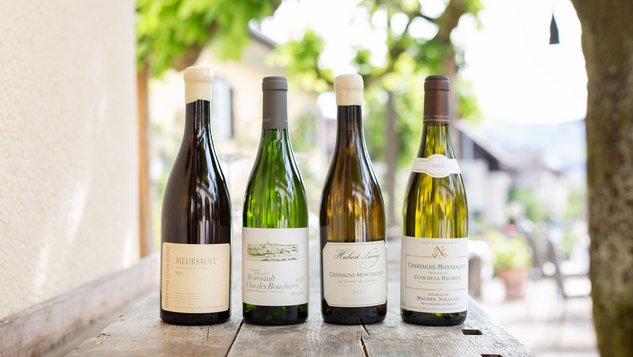 You can see different wines in the background a green garden